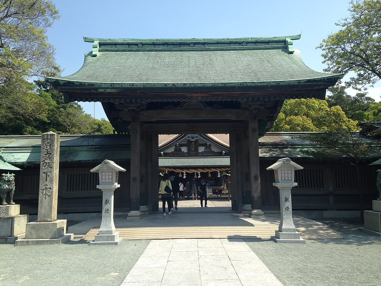The sacred gate (Shimmon) of Munakata Taisha Hetsu-gu, with visitors passing through