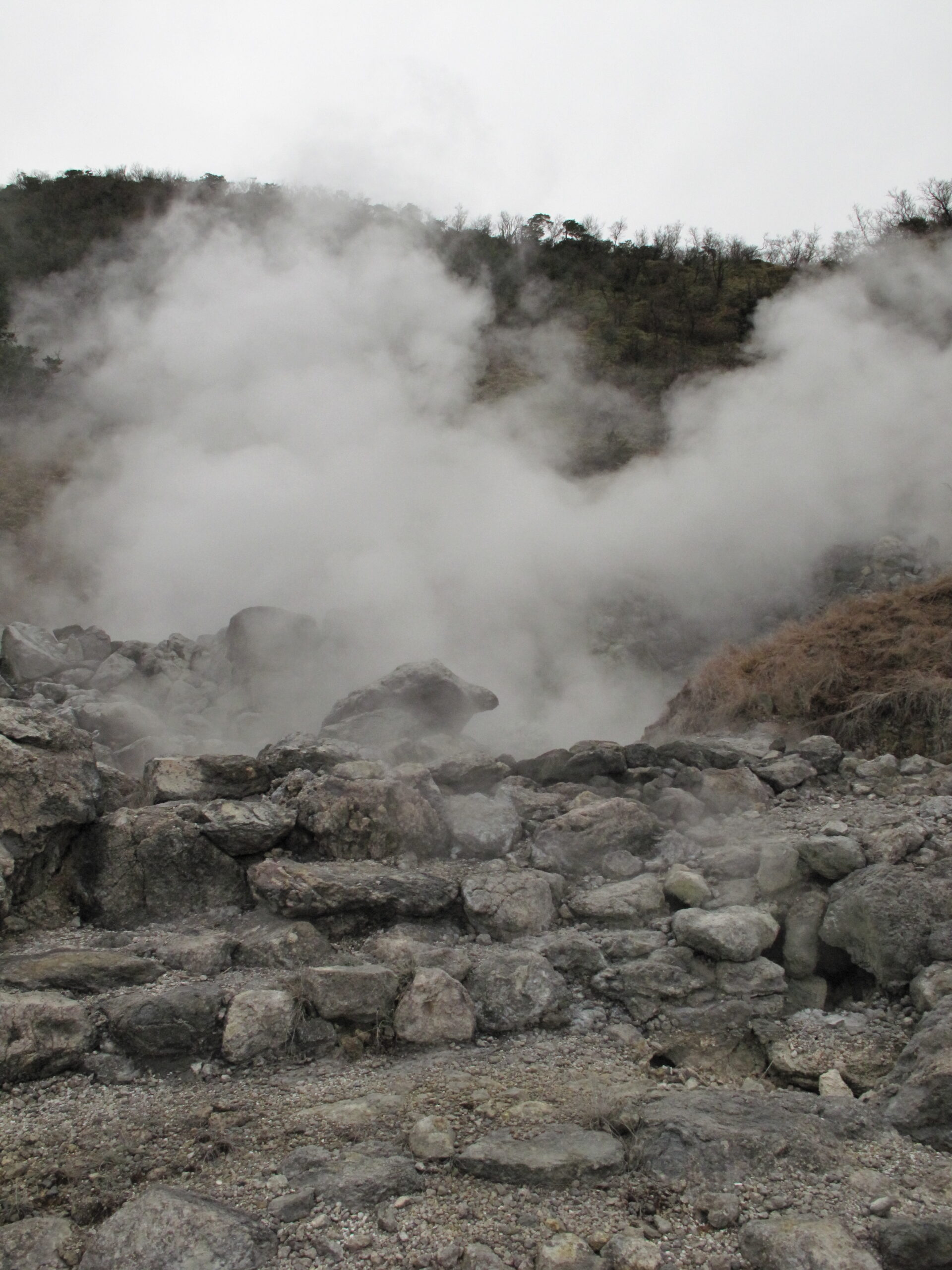 Close-up of volcanic steam rising from rocks