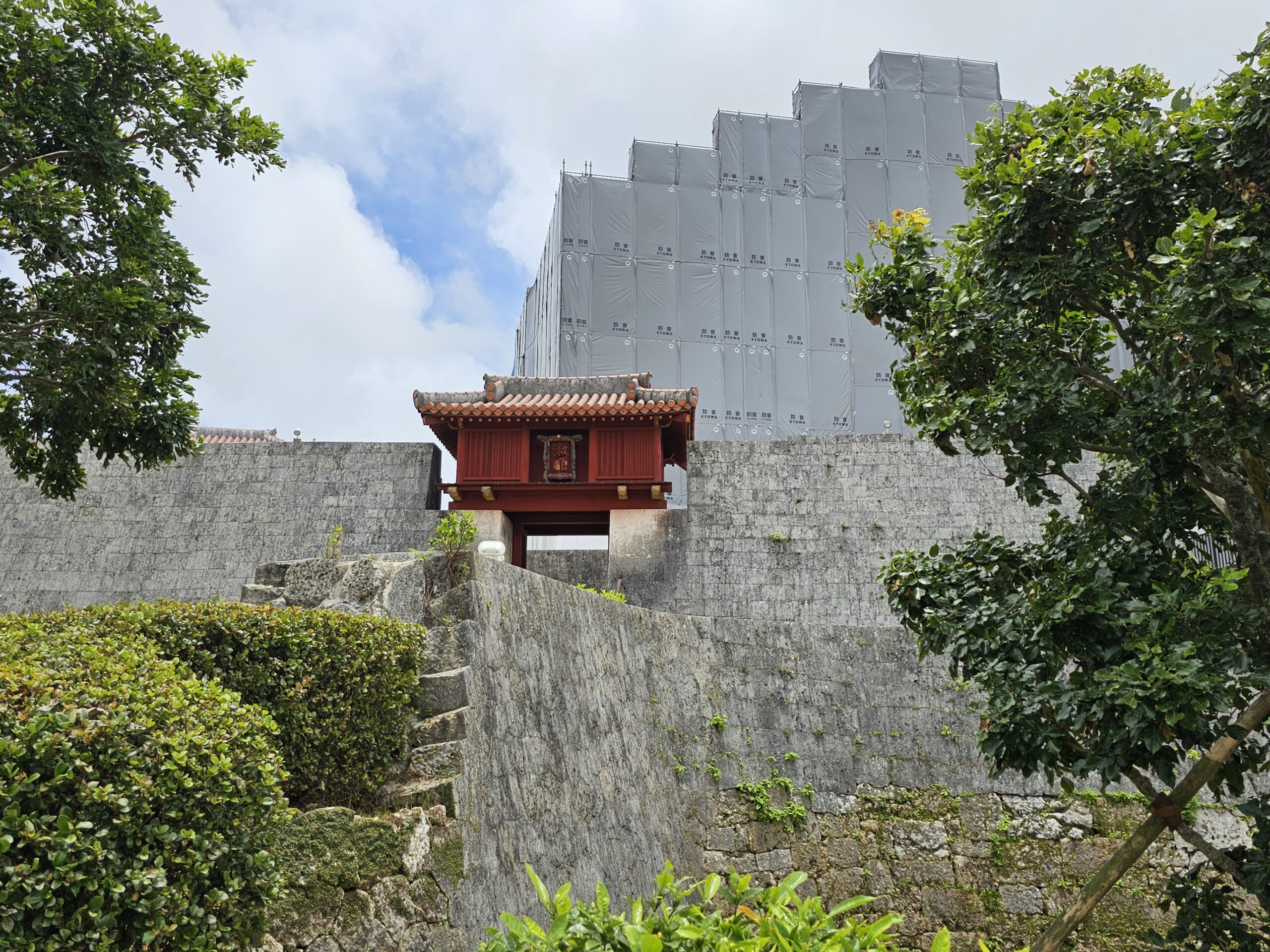 Shuri Castle during the reconstruction period, seen past a gate